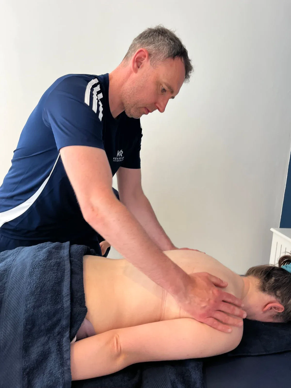 Ken treating a client on the treatment table